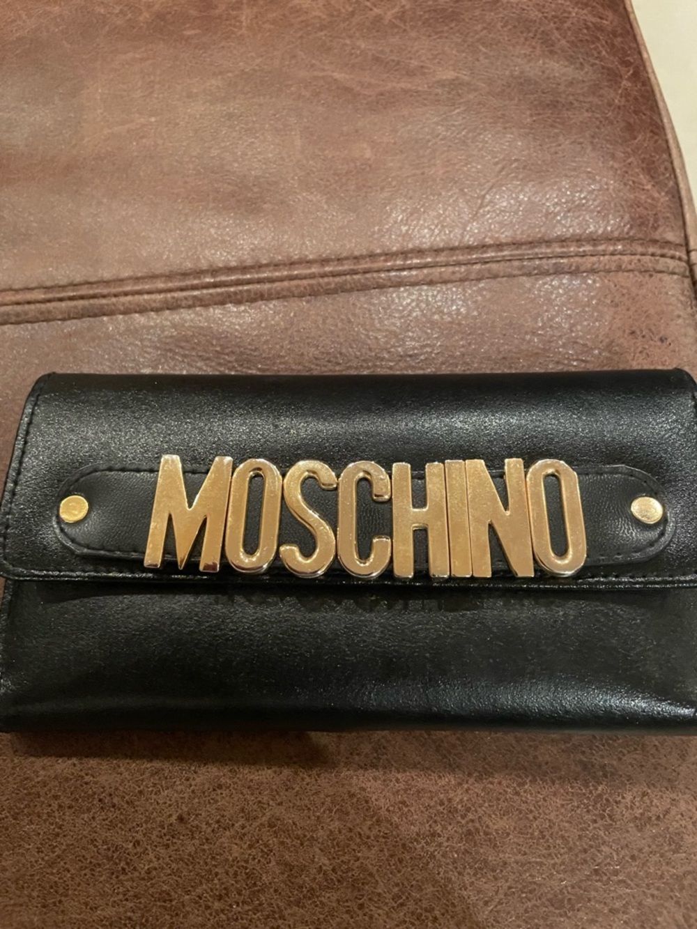 Moschino Black Wallet with Prominent Gold Lettering